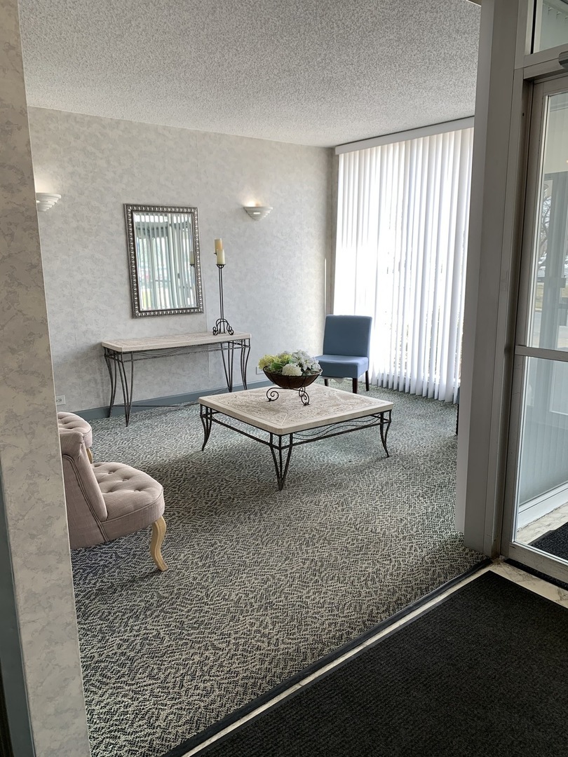 8809 Golf Road, Unit 8A Niles, IL 60714 - Photo 12 of 12 a living room with furniture and a window