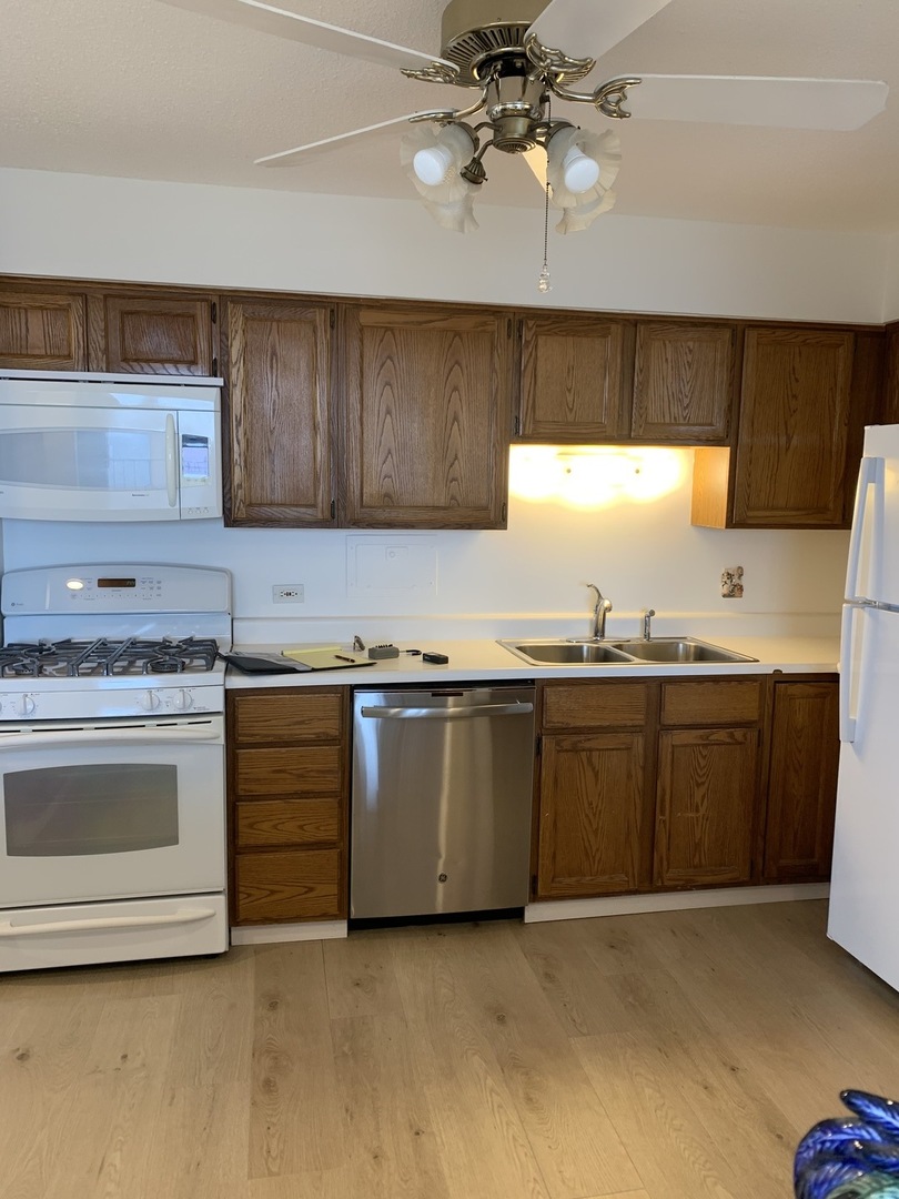 8809 Golf Road, Unit 8A Niles, IL 60714 - Photo 5 of 12 a kitchen with granite countertop a sink cabinets and stainless steel appliances