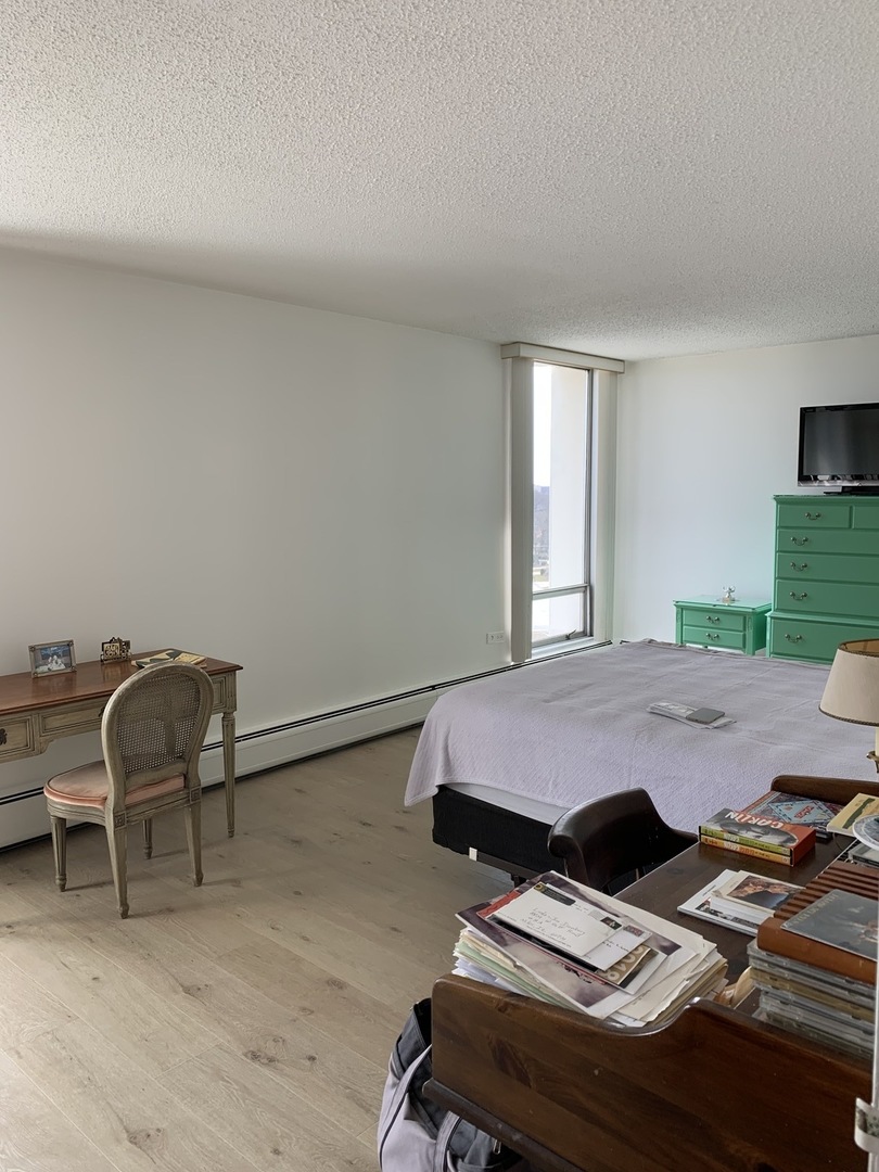 8809 Golf Road, Unit 8A Niles, IL 60714 - Photo 7 of 12 a bed room with a desk and a chair