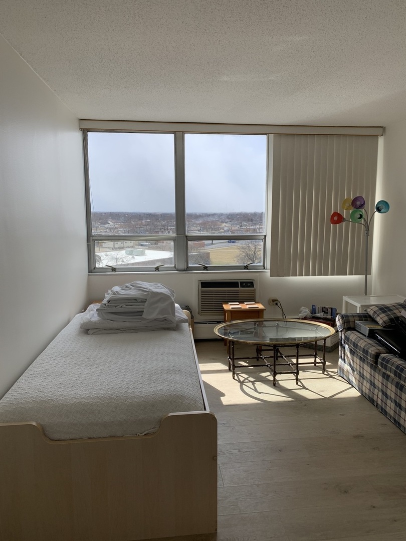 8809 Golf Road, Unit 8A Niles, IL 60714 - Photo 9 of 12 a living room with furniture and a large window
