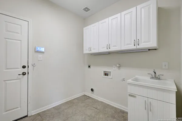a bathroom with a sink and cabinets