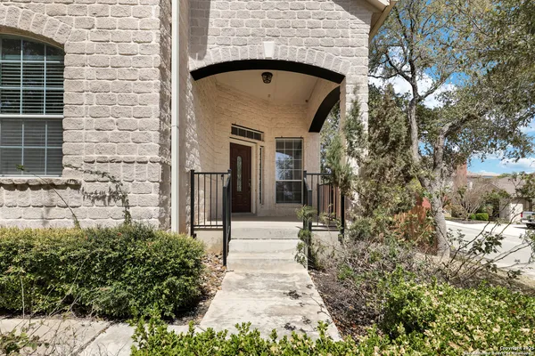 a view of entrance gate of house and trees