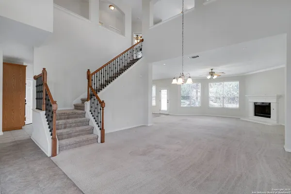 a view of entryway and hall with chandelier