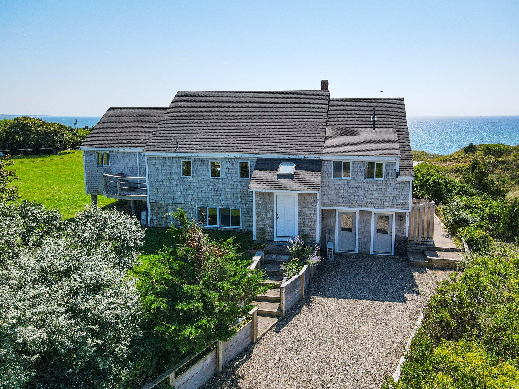 a aerial view of a house next to a yard