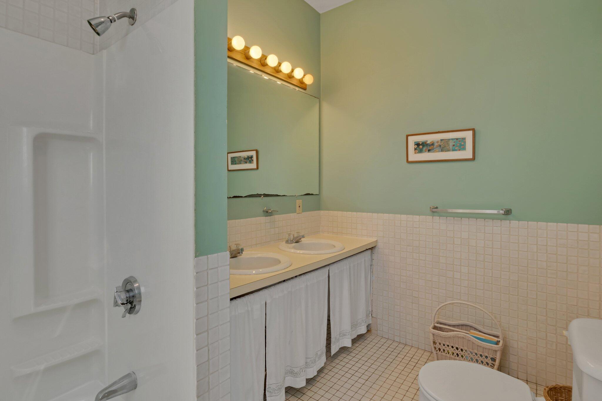12 Twine Field Road Truro, MA 02666 - Photo 11 of 25 a bathroom with a granite countertop sink a toilet and a mirror