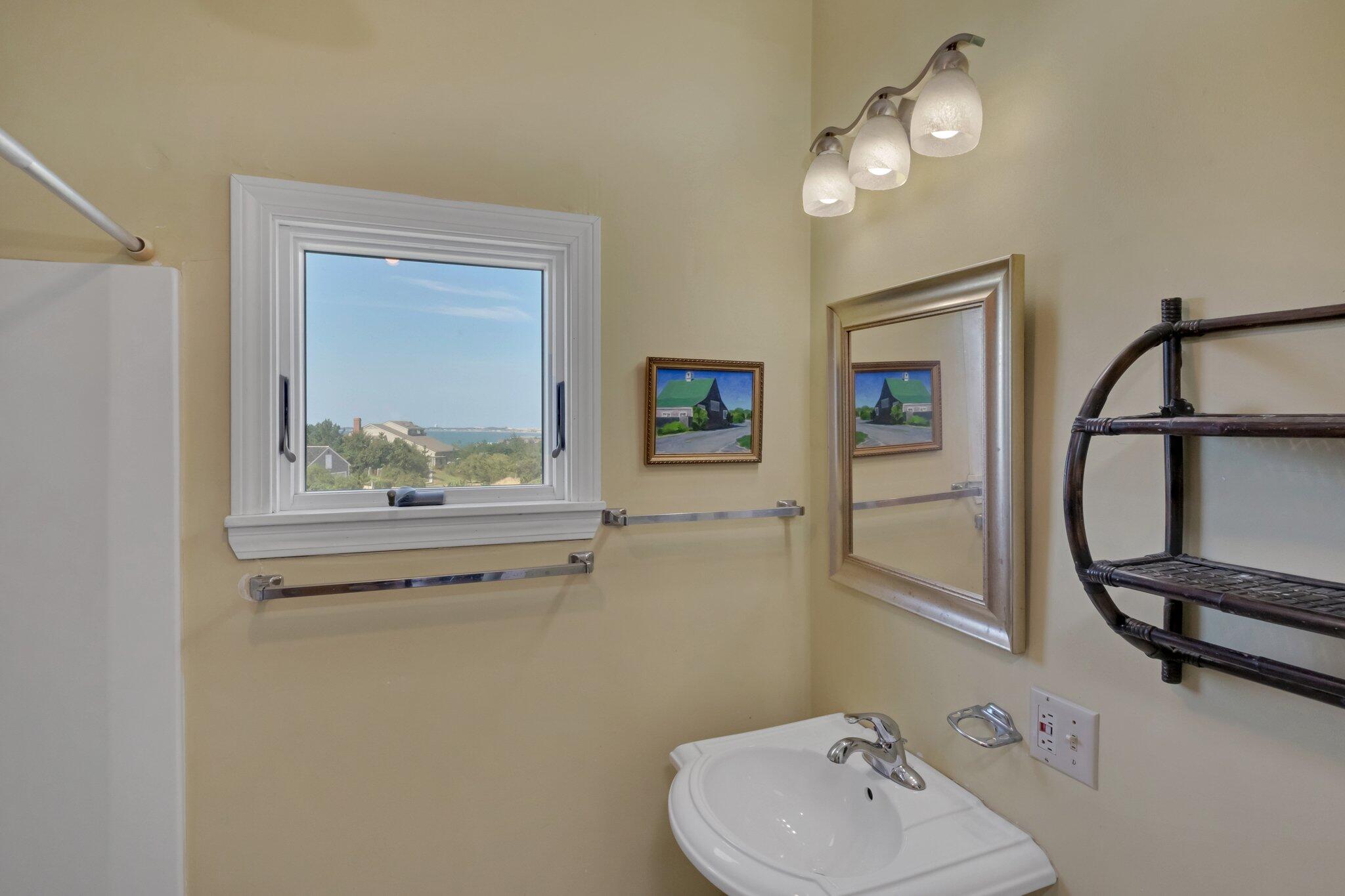 12 Twine Field Road Truro, MA 02666 - Photo 19 of 25 a bathroom with a sink a mirror and vanity