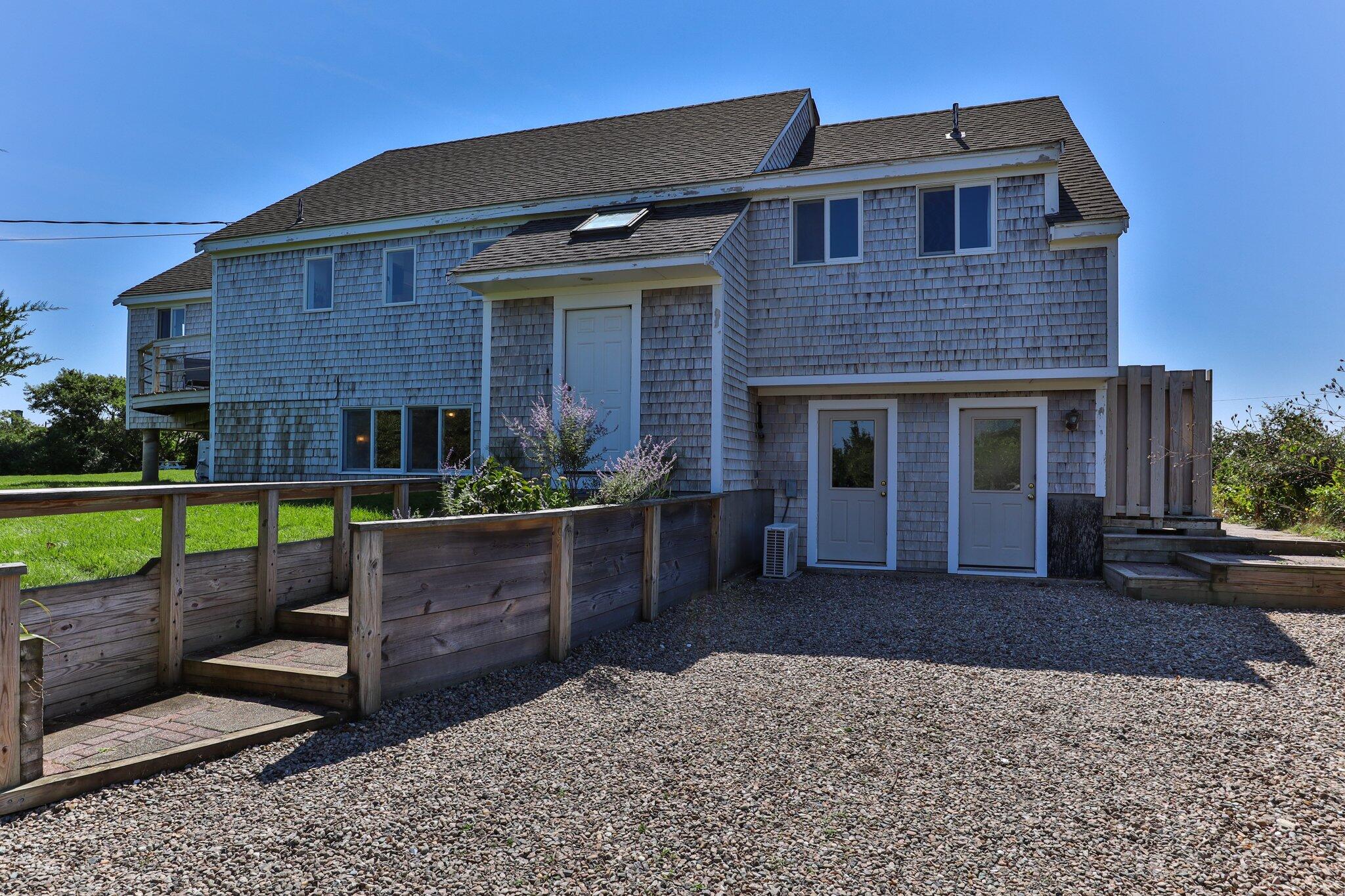 12 Twine Field Road Truro, MA 02666 - Photo 2 of 25 a front view of a house with a yard