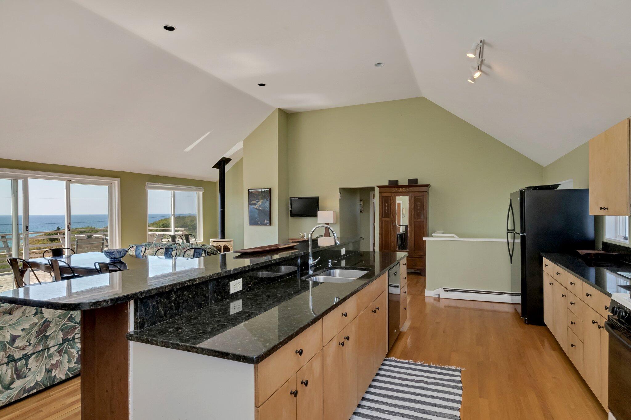 12 Twine Field Road Truro, MA 02666 - Photo 9 of 25 a kitchen with granite countertop a sink and a refrigerator