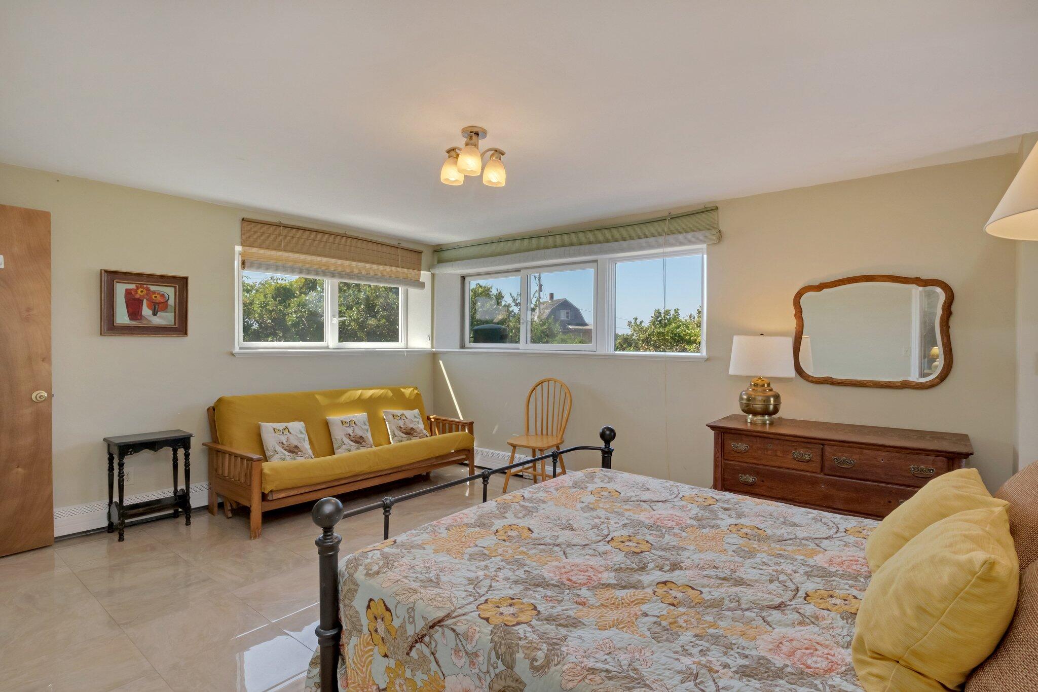 12 Twine Field Road Truro, MA 02666 - Photo 10 of 25 a bedroom with a bed a dresser and next to a window