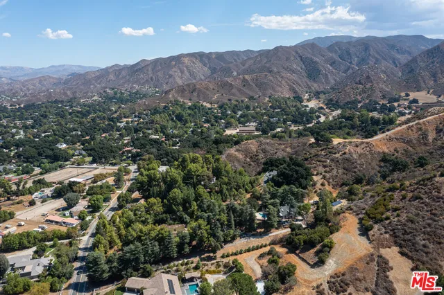 an aerial view of residential house and sandy dunes