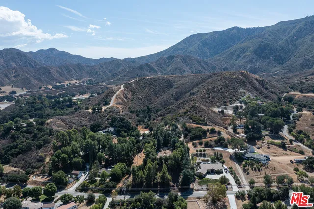 an aerial view of multiple houses with yard