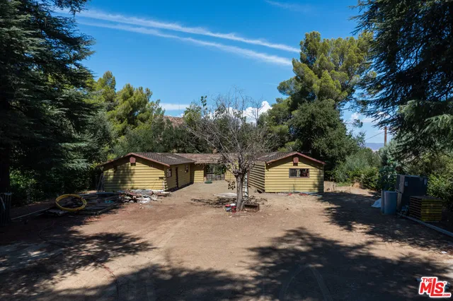 a view of house with outdoor space and sitting area