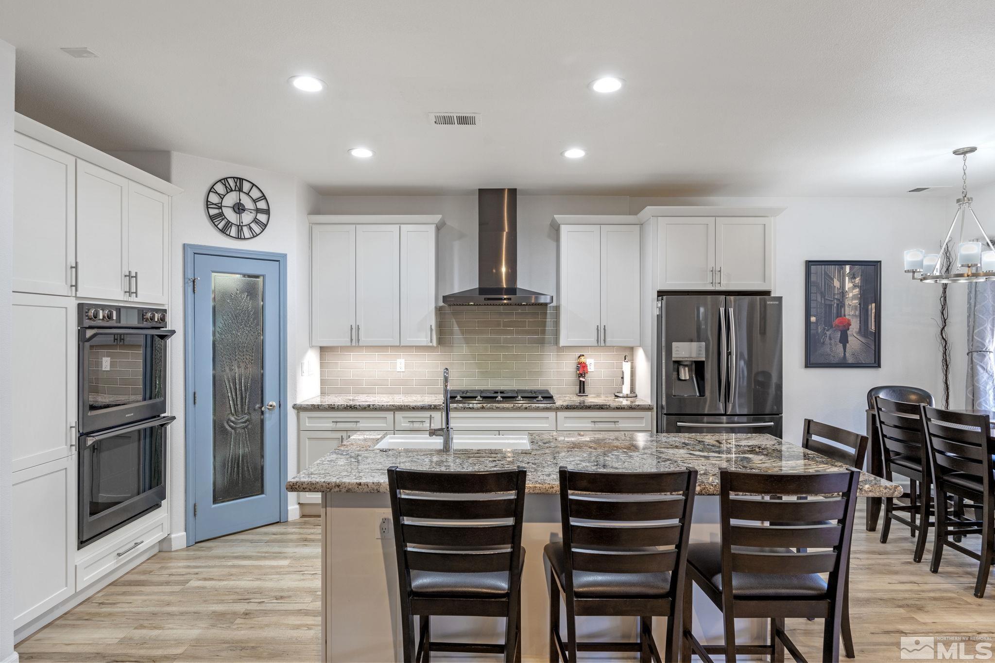 1601 Red Gulch Court Reno, NV 89521 - Photo 10 of 35 a kitchen with kitchen island cabinets and stainless steel appliances
