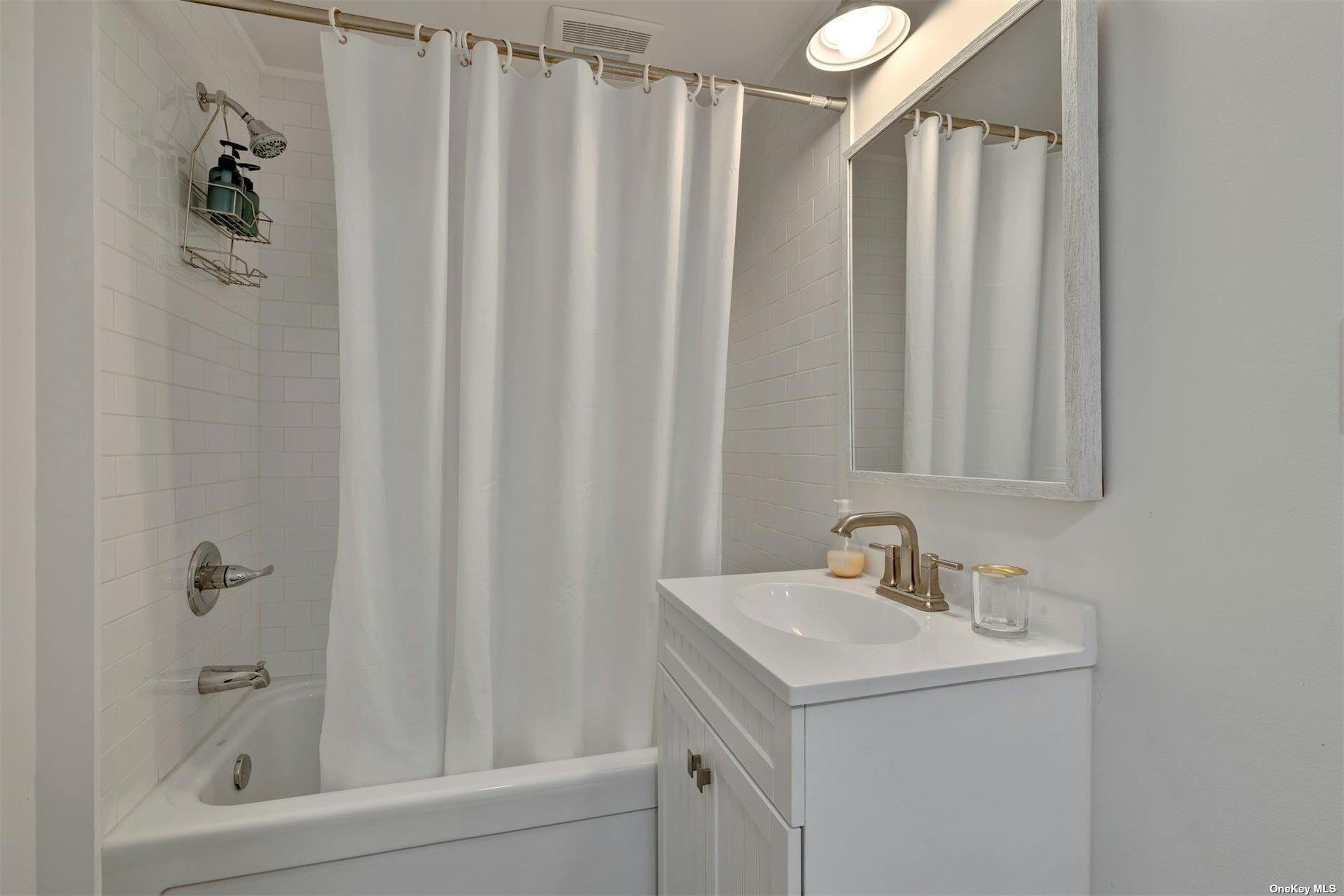 3670 Rocky Point Road East Marion, NY 11939 - Photo 13 of 26 a bathroom with a sink and a mirror
