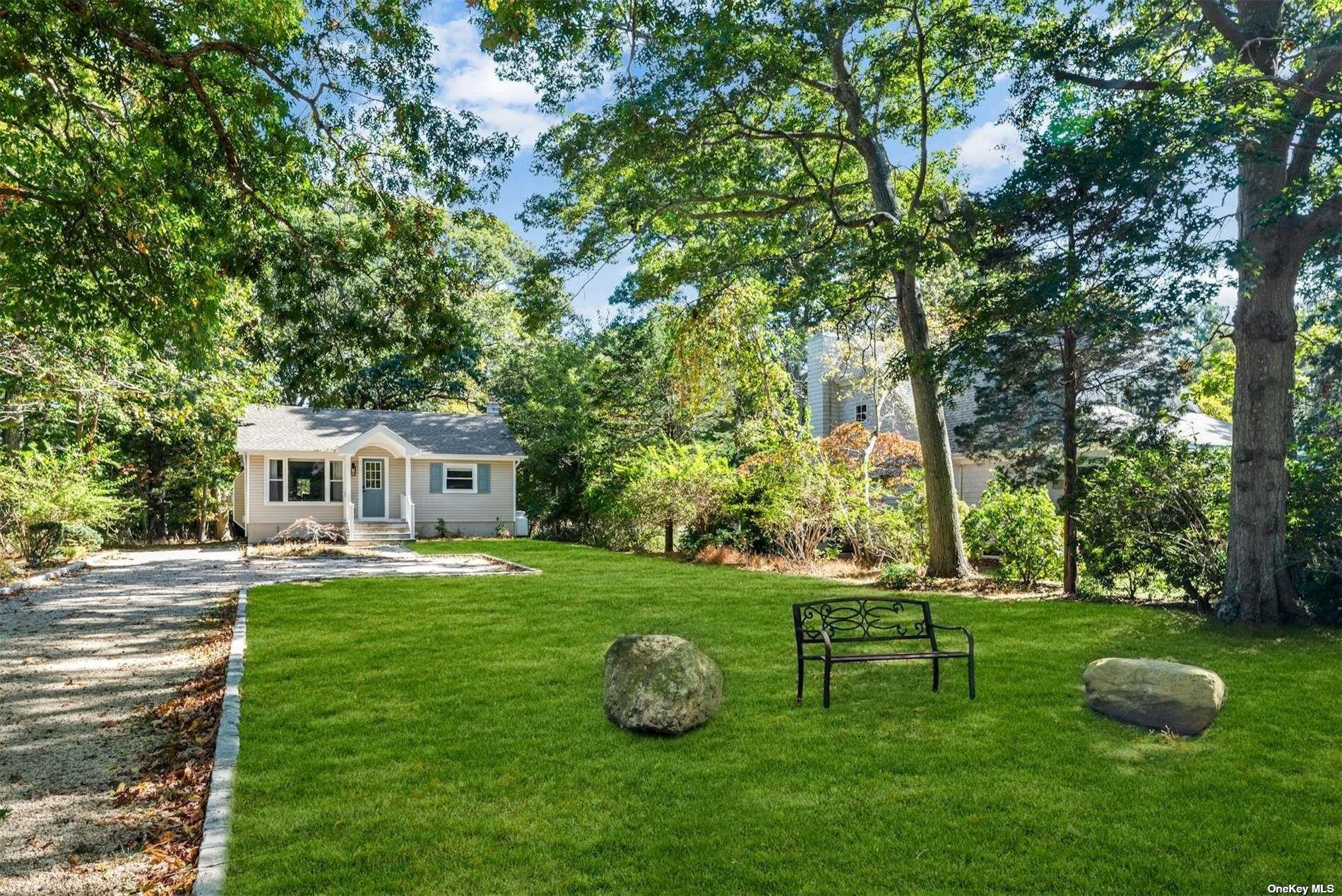 3670 Rocky Point Road East Marion, NY 11939 - Photo 21 of 26 a front view of a house with garden and trees