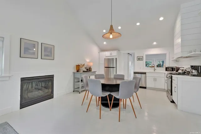 a open kitchen with white cabinets and stainless steel appliances