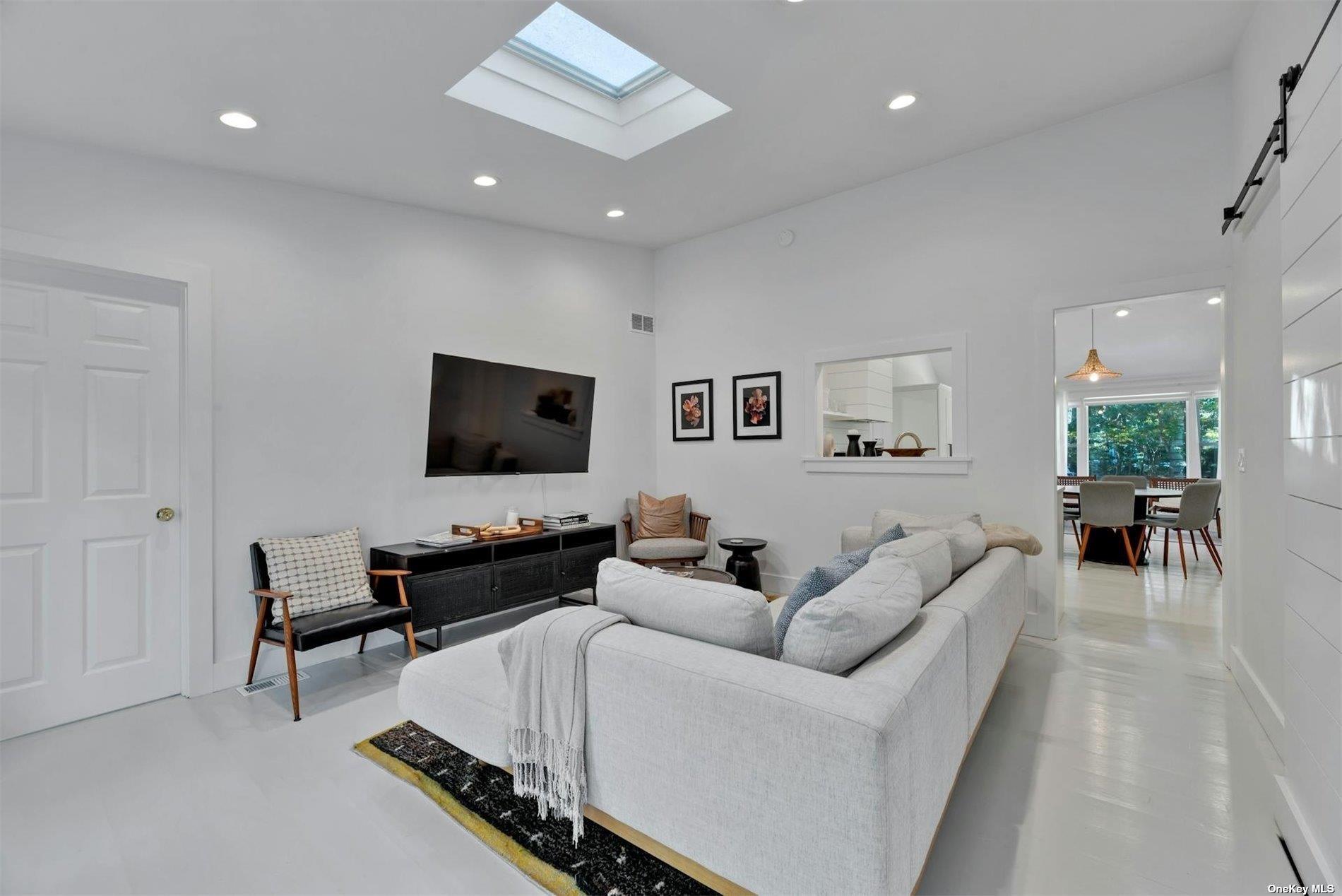 3670 Rocky Point Road East Marion, NY 11939 - Photo 8 of 26 a living room with furniture and a flat screen tv