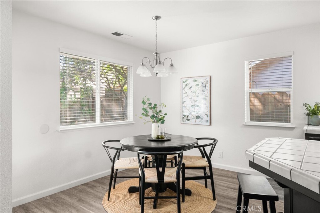 259 Picholine Way Chico, CA 95928 - Photo 20 of 38 a dining room with furniture a chandelier and wooden floor