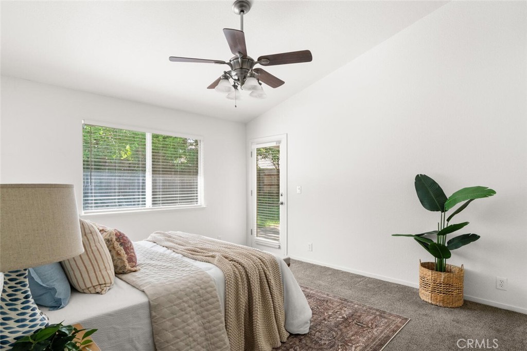 259 Picholine Way Chico, CA 95928 - Photo 24 of 38 a bedroom with a bed and a potted plant