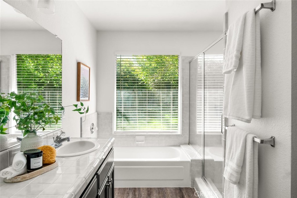 259 Picholine Way Chico, CA 95928 - Photo 26 of 38 a bathroom with a tub a potted plant and a large window