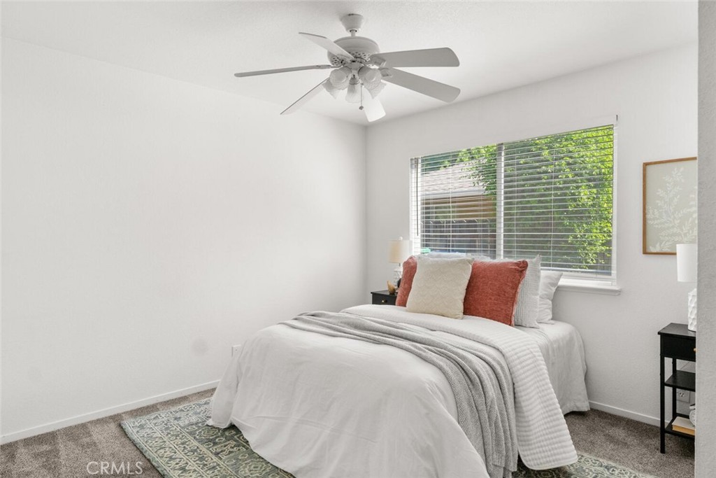 259 Picholine Way Chico, CA 95928 - Photo 27 of 38 a bedroom with a bed and a chandelier