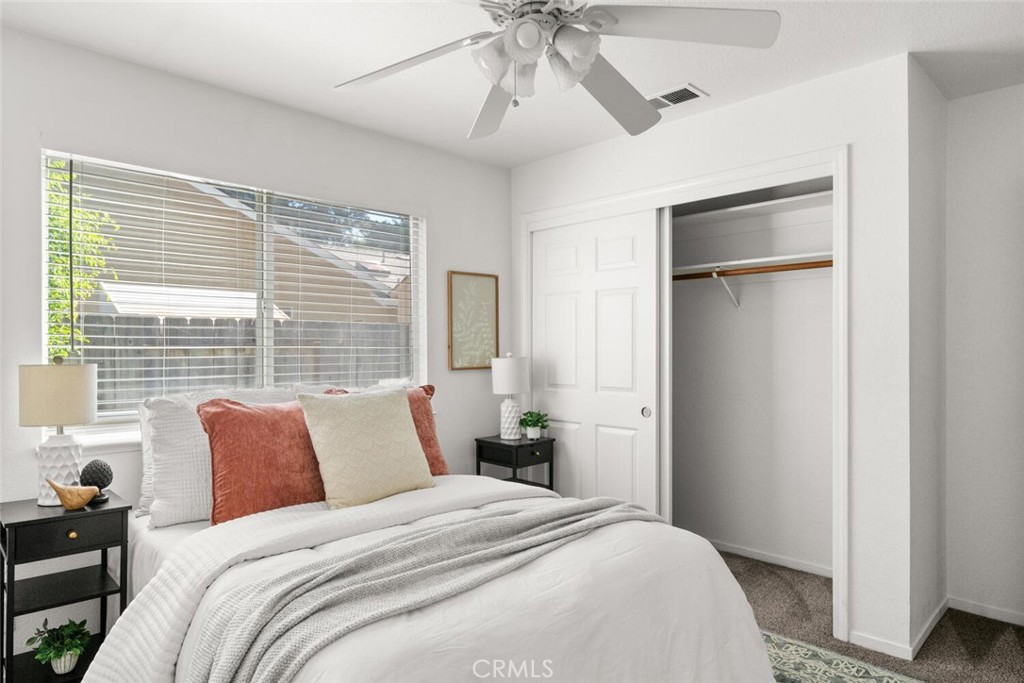 259 Picholine Way Chico, CA 95928 - Photo 28 of 38 a bedroom with a bed and a chandelier