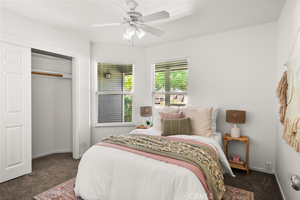 259 Picholine Way Chico, CA 95928 - Photo 30 of 38 a bedroom with a large bed and a chandelier