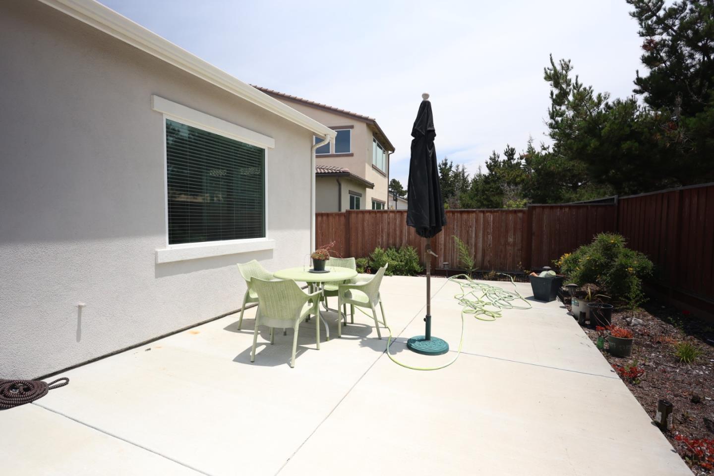 478 Logan Way Marina, CA 93933 - Photo 27 of 42 a view of a patio with table and chairs potted plants with wooden fence