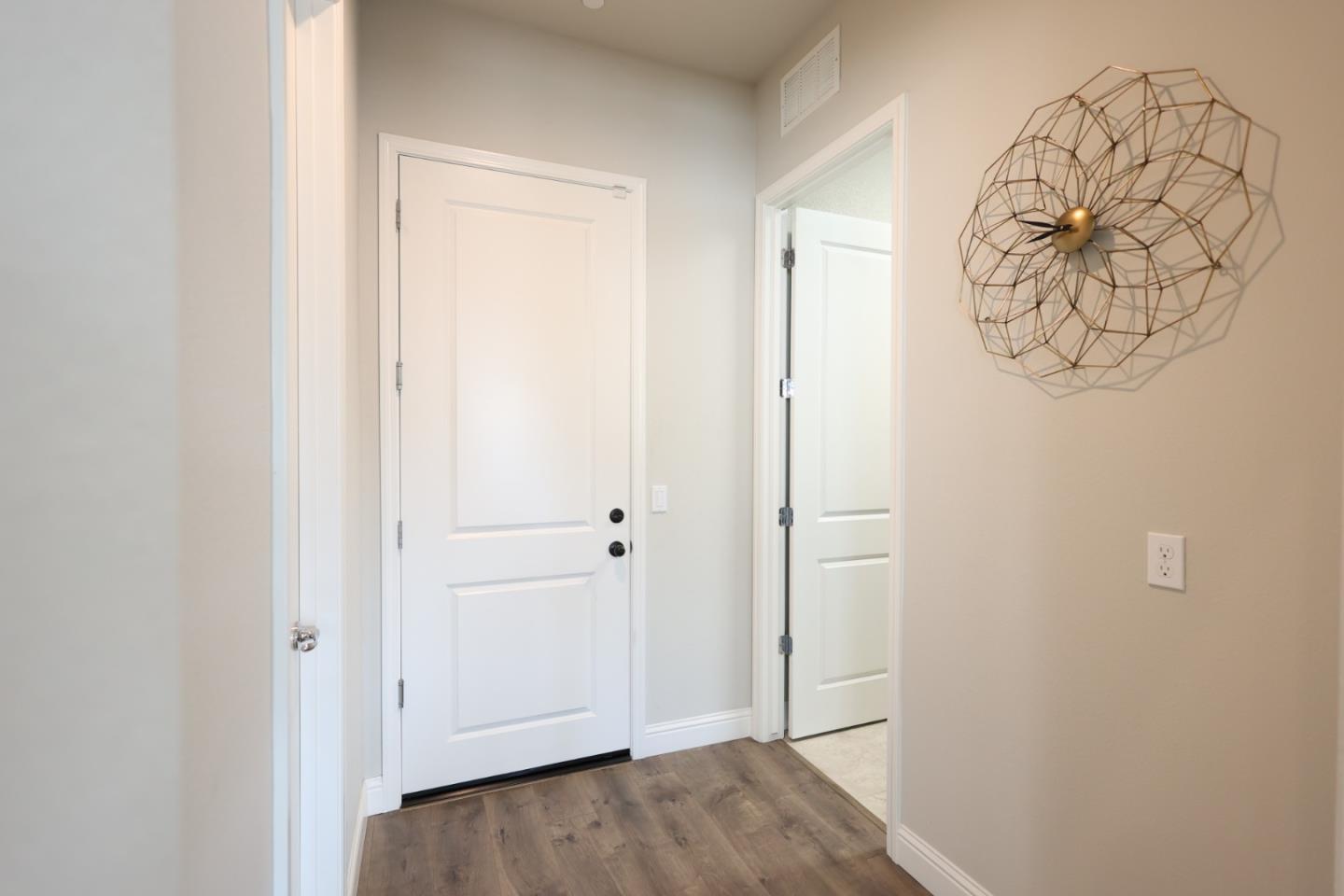 478 Logan Way Marina, CA 93933 - Photo 38 of 42 a view of a hallway with wooden floor and a bathroom