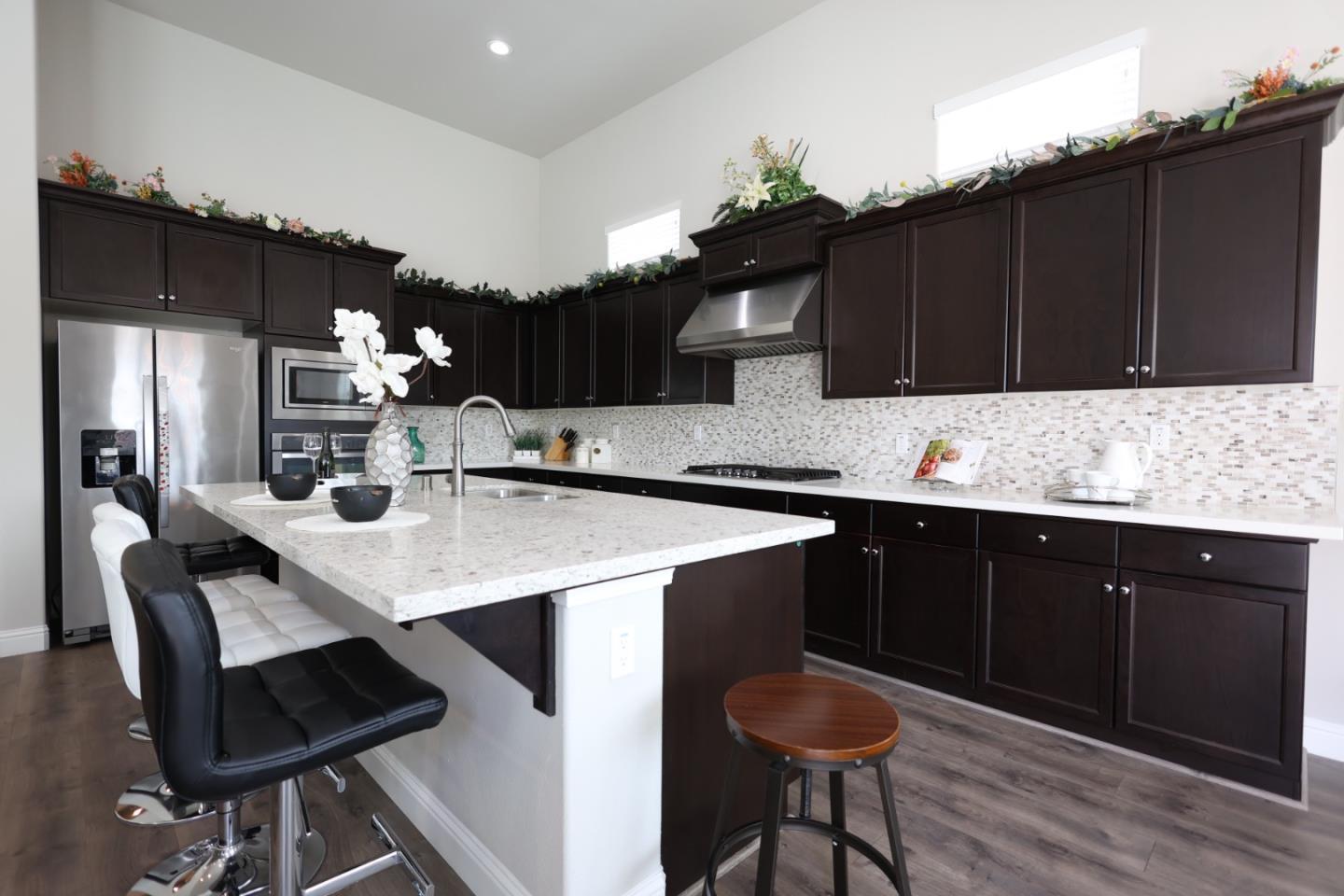 478 Logan Way Marina, CA 93933 - Photo 8 of 42 a kitchen with granite countertop a sink cabinets and wooden floor