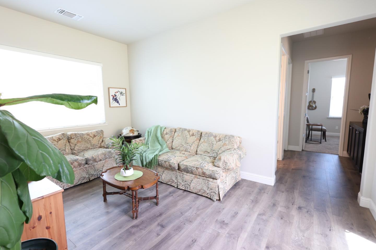 478 Logan Way Marina, CA 93933 - Photo 9 of 42 a living room with furniture and a wooden floor