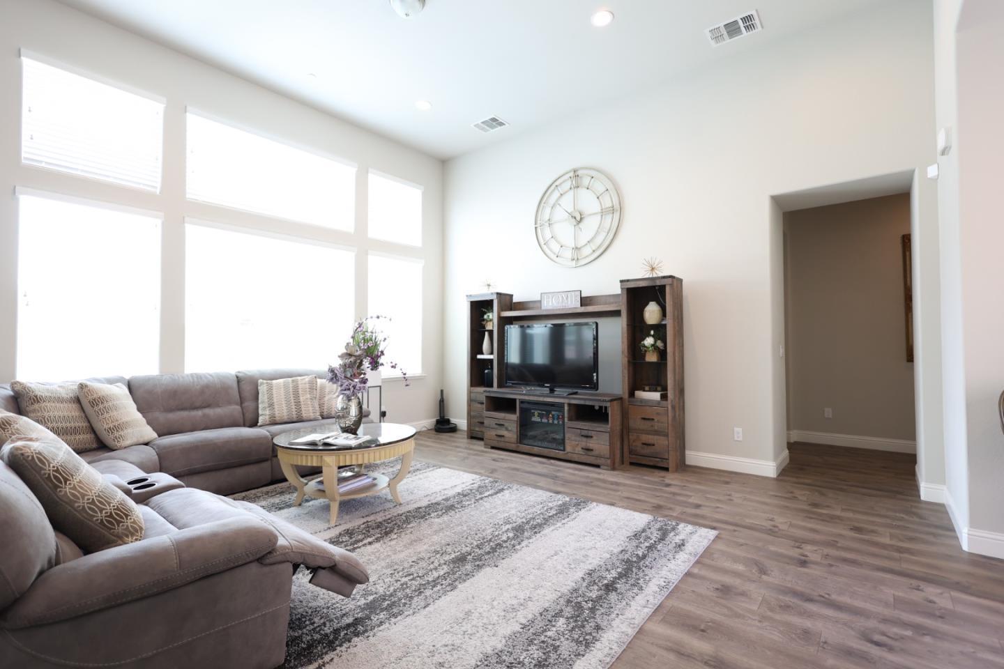 478 Logan Way Marina, CA 93933 - Photo 10 of 42 a living room with furniture a flat screen tv and a large window