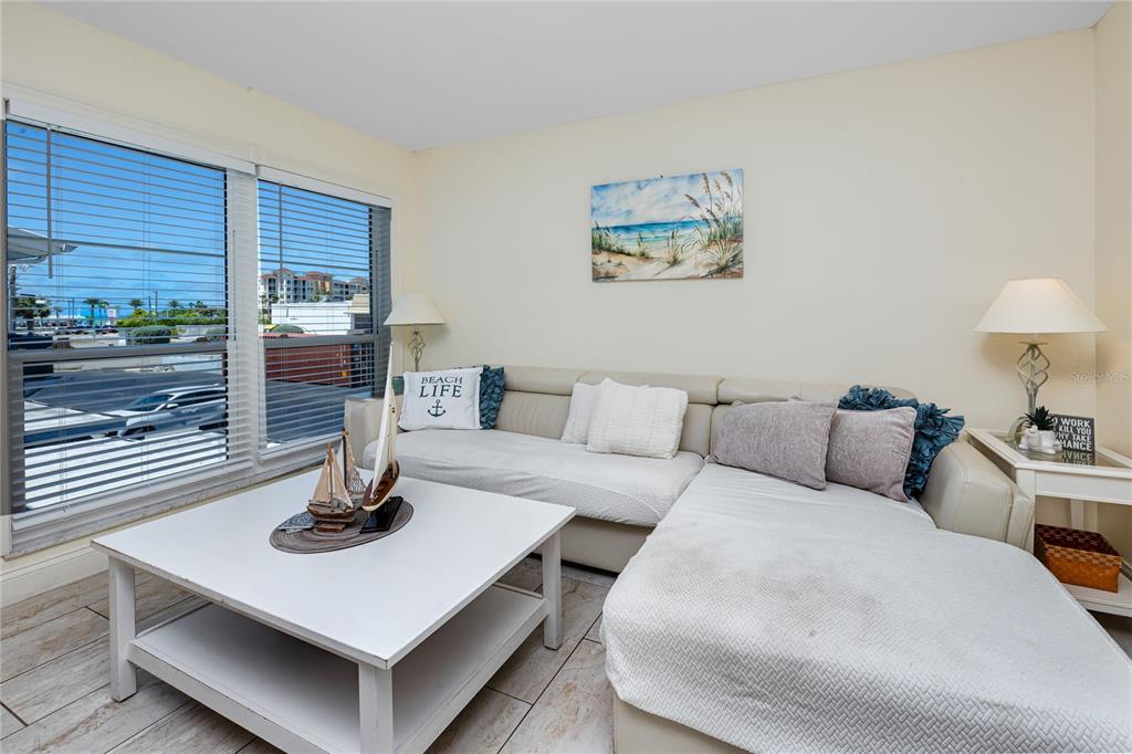 159 Medallion Boulevard, Unit F Madeira Beach, FL 33708 - Photo 11 of 47 a living room with furniture and a table