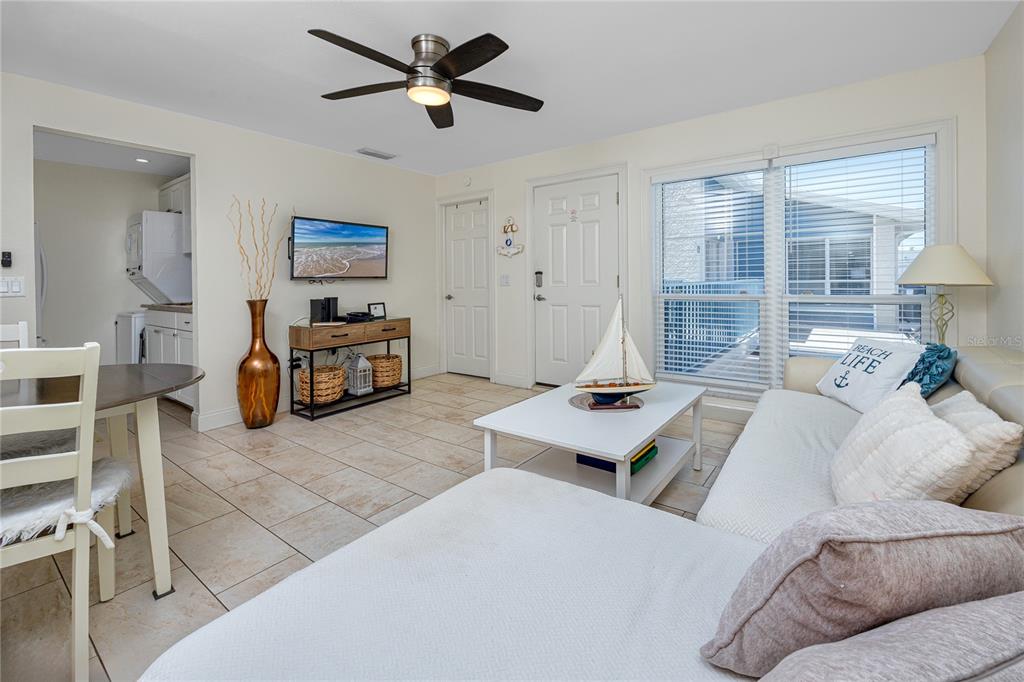 159 Medallion Boulevard, Unit F Madeira Beach, FL 33708 - Photo 12 of 47 a living room with furniture and a window