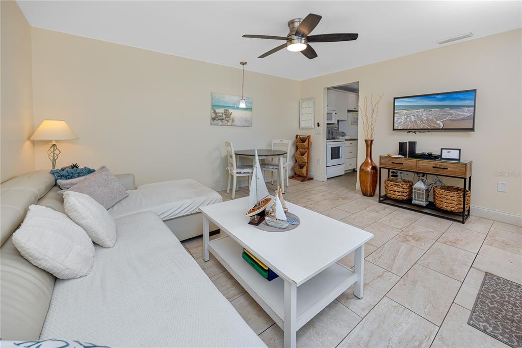159 Medallion Boulevard, Unit F Madeira Beach, FL 33708 - Photo 13 of 47 a living room with furniture and a table