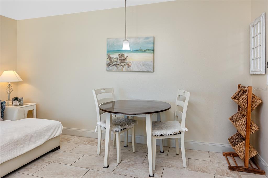 159 Medallion Boulevard, Unit F Madeira Beach, FL 33708 - Photo 15 of 47 a bedroom with a bed and a table in it