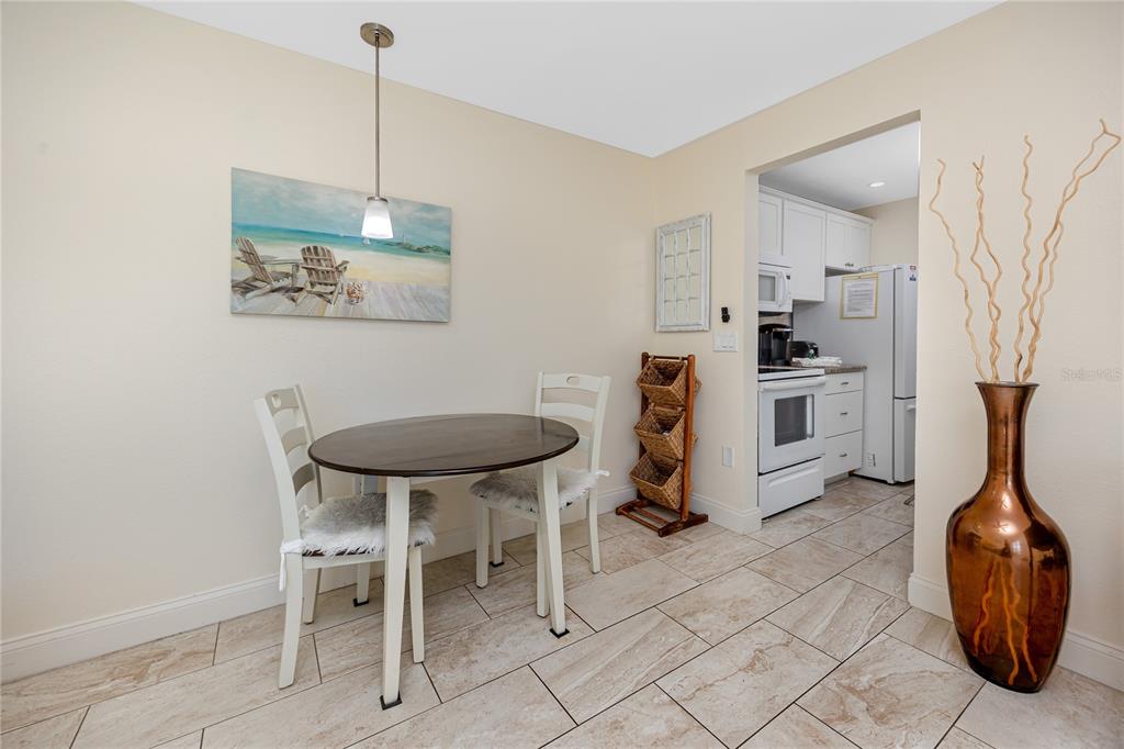 159 Medallion Boulevard, Unit F Madeira Beach, FL 33708 - Photo 17 of 47 a view of a kitchen with furniture and wooden floor