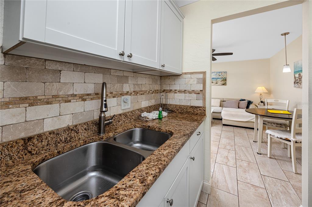 159 Medallion Boulevard, Unit F Madeira Beach, FL 33708 - Photo 22 of 47 a kitchen with a sink and cabinets
