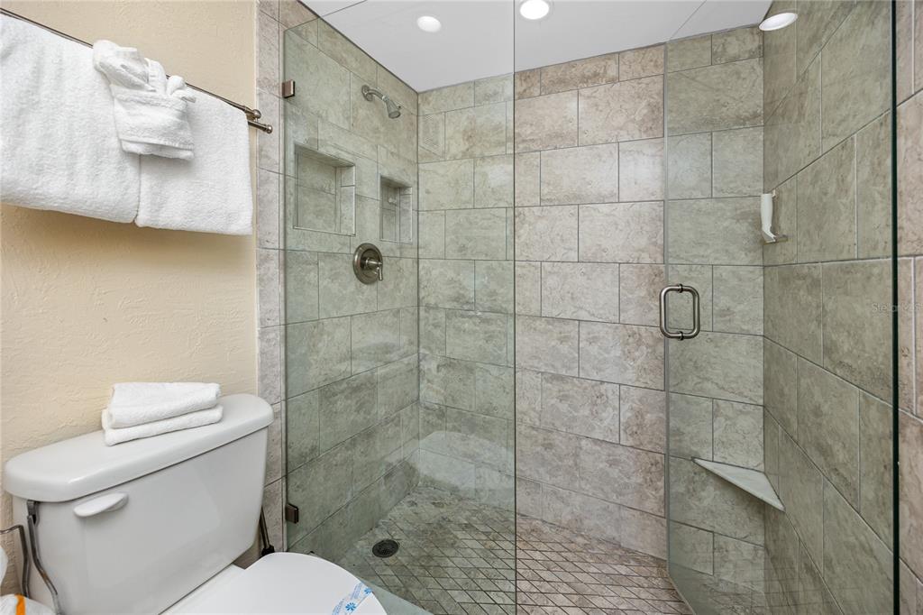 159 Medallion Boulevard, Unit F Madeira Beach, FL 33708 - Photo 29 of 47 a bathroom with a shower a toilet and a sink
