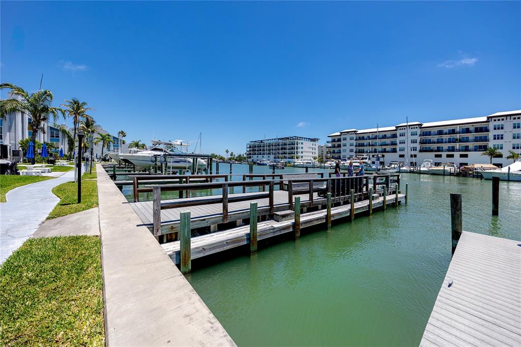 159 Medallion Boulevard, Unit F Madeira Beach, FL 33708 - Photo 34 of 47 a view of a lake with a terrace