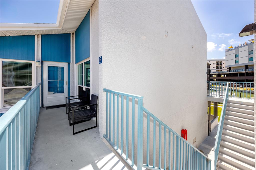 159 Medallion Boulevard, Unit F Madeira Beach, FL 33708 - Photo 4 of 47 a view of a balcony with chairs
