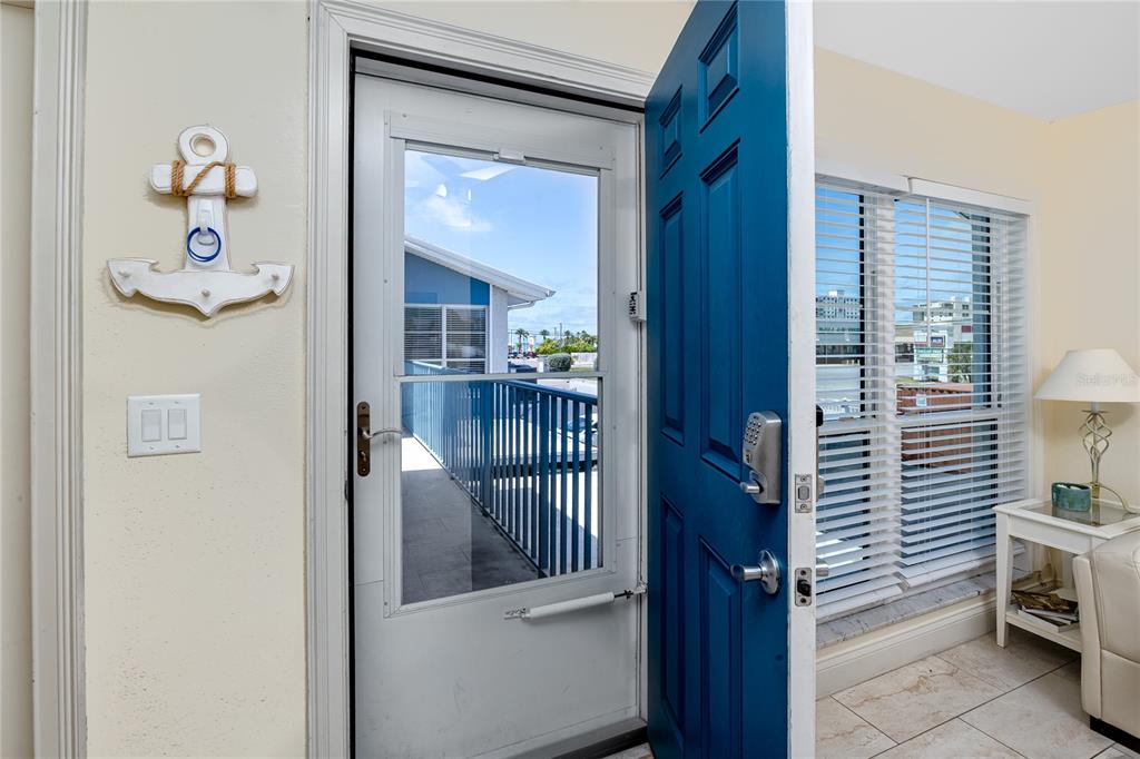 159 Medallion Boulevard, Unit F Madeira Beach, FL 33708 - Photo 6 of 47 a view of a hallway and a livingroom with furniture
