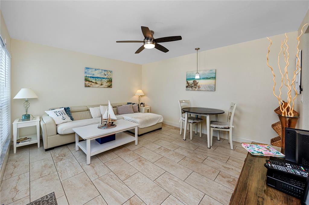 159 Medallion Boulevard, Unit F Madeira Beach, FL 33708 - Photo 7 of 47 a living room with furniture and a flat screen tv