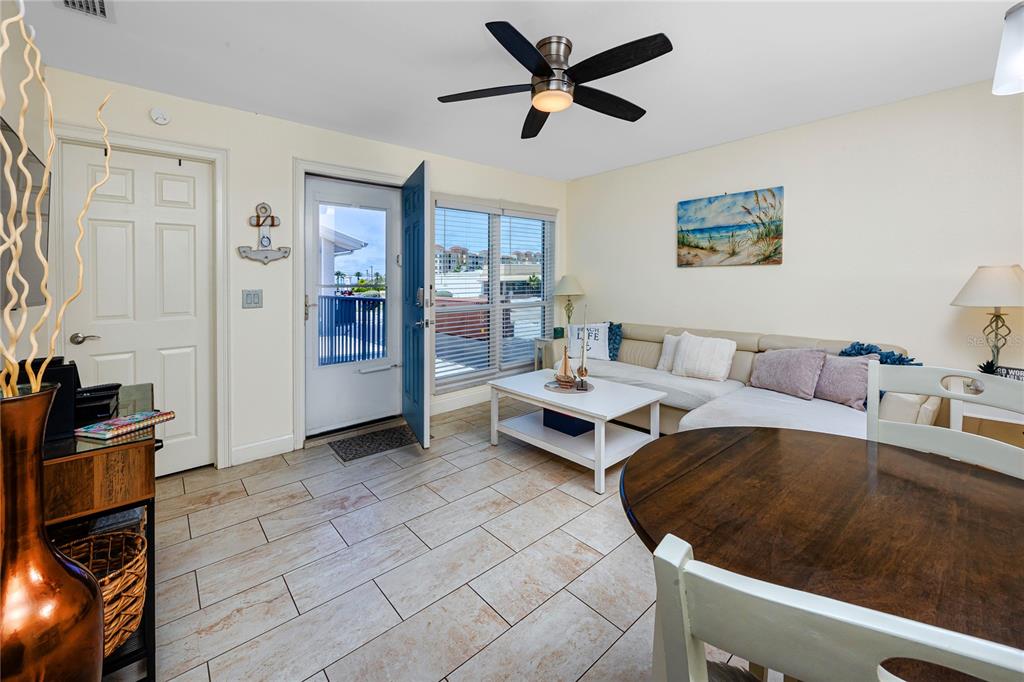 159 Medallion Boulevard, Unit F Madeira Beach, FL 33708 - Photo 8 of 47 a living room with furniture and a rug
