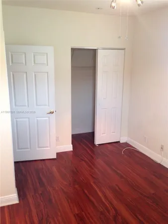 an empty room with wooden floor