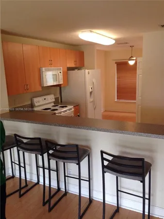 a kitchen with a table and chairs