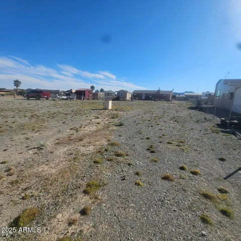 a view of a dry field with lots of bushes