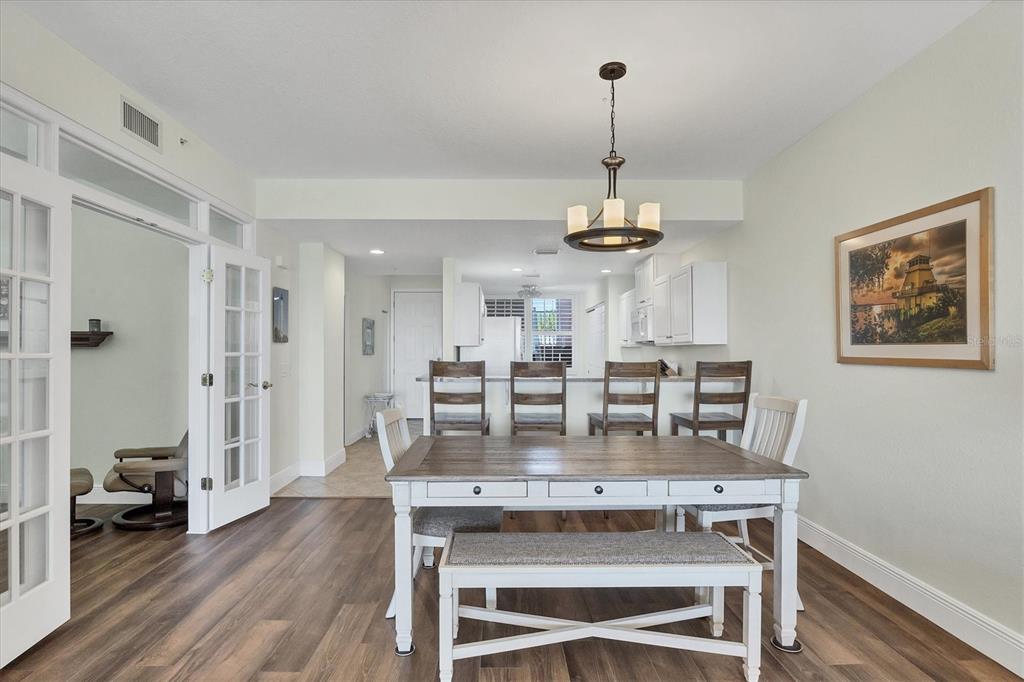 13313 Gasparilla Road, Unit 202 Placida, FL 33946 - Photo 22 of 57 a view of a dining room with furniture wooden floor and a chandelier