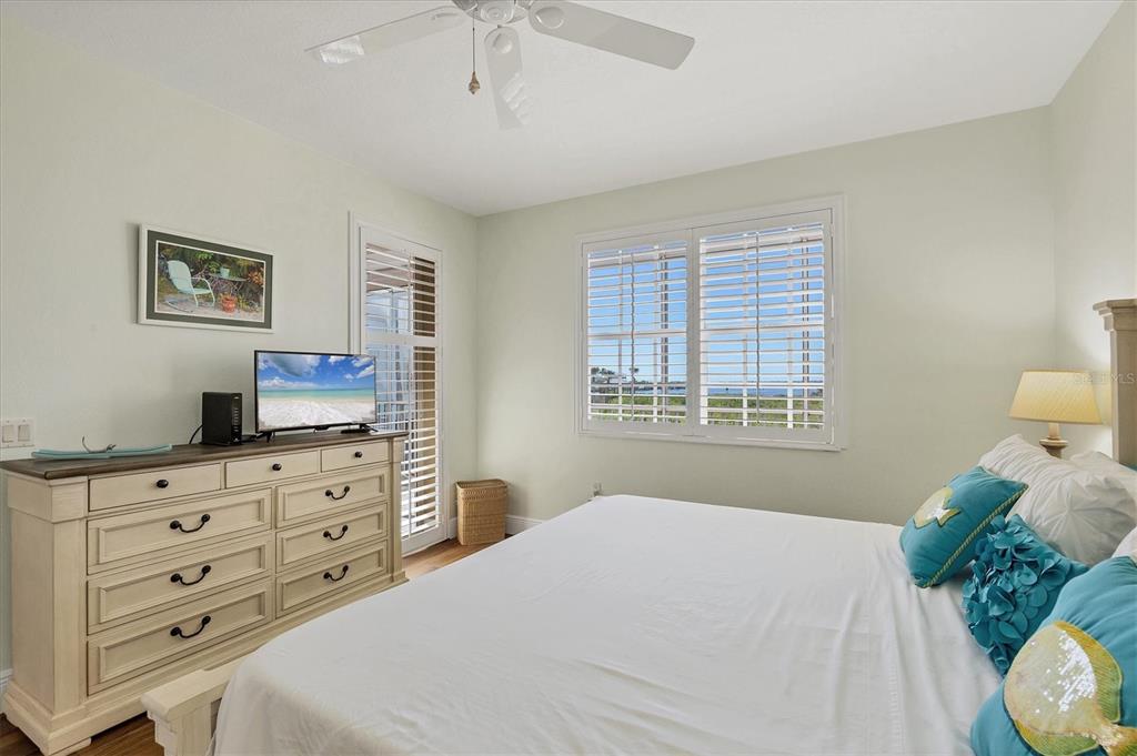 13313 Gasparilla Road, Unit 202 Placida, FL 33946 - Photo 25 of 57 a bedroom with a bed and a dresser in it