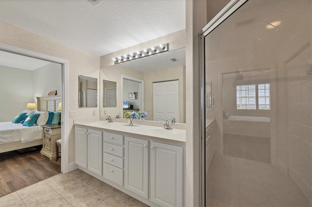 13313 Gasparilla Road, Unit 202 Placida, FL 33946 - Photo 29 of 57 a spacious bathroom with a double vanity sink and a mirror